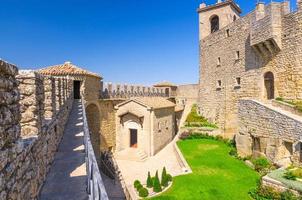 Courtyard with green grass lawn of Prima Torre Guaita first medieval tower photo
