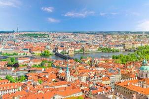Top aerial panoramic view of Prague historical city centre with red tiled roof buildings photo