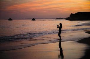 Portugal, Algarve, The best beaches of Portimao, Praia da Rocha, sunset over The Atlantic Ocean photo