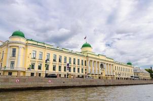 Leningrad Regional Court building on promenade of Fontanka river, blue dramatic sky background photo