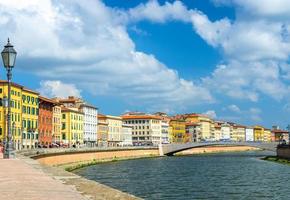 Row of old colorful buildings houses on embankment promenade of Arno river photo