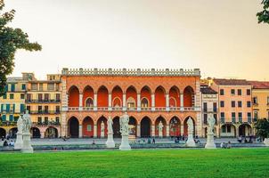 Padua cityscape with Palazzo Loggia Amulea palace neogothic style building and statues