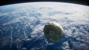 old soccer ball in space on Earth orbit video