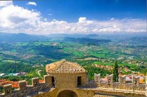 Aerial top panoramic view landscape with valley, green hills, fields, villages of Republic San Marino photo
