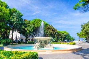 Quattro cavalli Four horses fountain with turquoise water in Parco Federico Fellini park photo