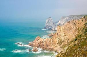 Cape Roca with sharp rocks and cliffs of Atlantic Ocean, Portugal photo