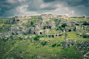 View of canyon with rocks and caves Murgia Timone, Matera Sassi, Italy photo