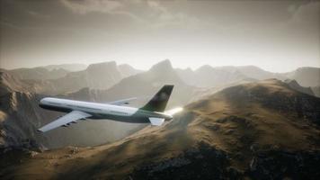Passenger aircraft over mountain landscape video