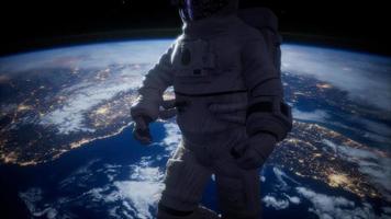 Astronaut in outer space against the backdrop of the planet earth video