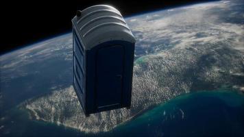 Portable street WC toilet cabin on Earth orbit. elements furnished by Nasa video