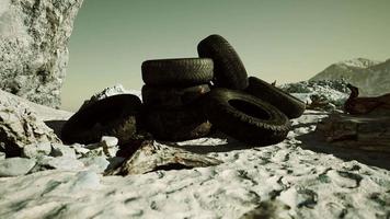 Old tire on the seashore and pollution of nature video