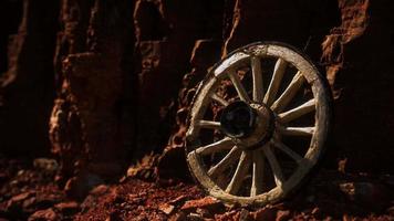 old wooden cart wheel on stone rocks video