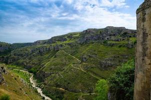 View of canyon with rocks and caves Murgia Timone, Matera Sassi, Italy photo