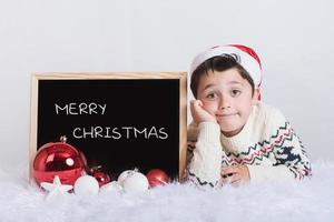 smiling boy with a blackboard at christmas photo