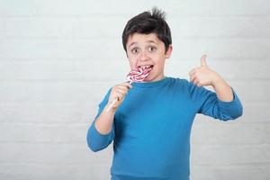 Funny kid with lollipop photo