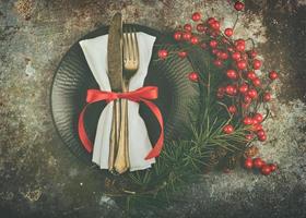 vintage old cutlery served on plate for Christmas Dinner with wreath photo