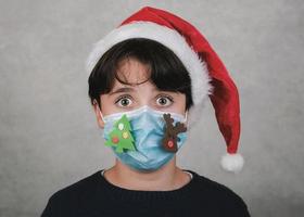 Merry Christmas,Close-up of kid with funny christmas medical mask photo