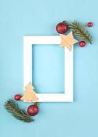 Christmas concept background.White frame with christmas decoration and fir tree branches photo