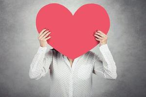 Young Woman holding red heart photo