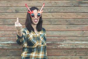 Portrait of young woman insulting with finger photo