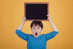 surprised boy with a blackboard photo
