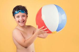 happy child playing with Beach ball photo