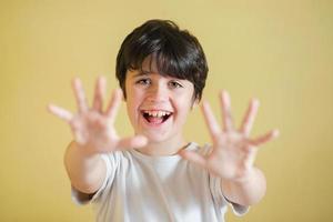happy kid spreading hands up,background blur