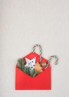 Christmas concept background.Red christmas envelope with christmas stars andpine branches photo