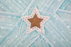 Merry Christmas.Protective surgical masks with christmas star photo