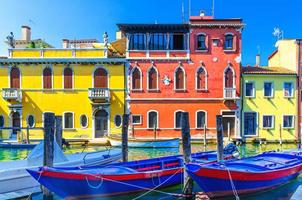 Chioggia cityscape with narrow water canal Vena with moored multicolored boats photo