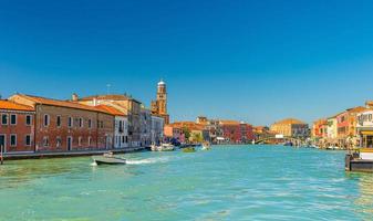 Murano islands with bridge across water canal, boats and motor boats photo