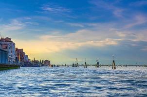 Yacht boats racing sailing on water of Venetian lagoon between wooden poles near Venice