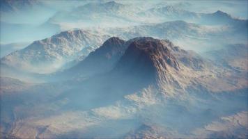 Distant mountain range and thin layer of fog on the valleys video