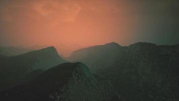 dramatic sky over rocky mountains at sunset video