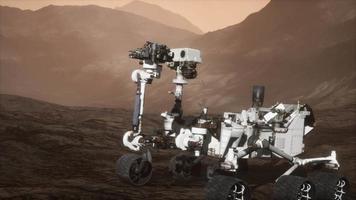 Curiosity Mars Rover exploring the surface of red planet. Elements of this image furnished by NASA video