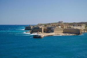 View of harbor entrance with lighthouse, Valletta, Malta photo