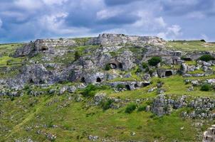 View of canyon with rocks and caves Murgia Timone, Matera Sassi, Italy photo