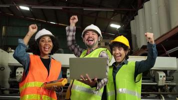 Multiracial engineer workers team in safety uniforms hard hats celebrate, hands raised together, happy and cheerful, industry jobs successful, achievement, professional technician manufacture factory. video