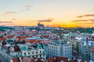 Top aerial panoramic view of Prague Old Town historical city centre with red tiled roof buildings and Prague Castle photo