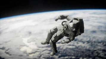 Astronaut floating above the Earth Elements of this image furnished by NASA