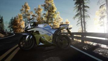 sportbike on tre road in forest with sun beams video