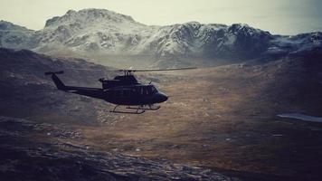 slow motion Vietnam War era helicopter in mountains video