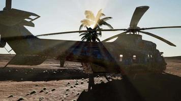 old rusted military helicopter in the desert at sunset video