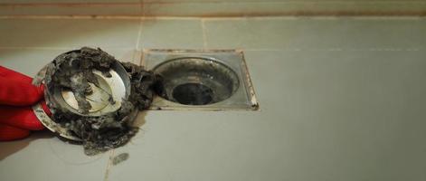 Drain cleaning. Clogged and dirty sewer pipes floor drain. photo