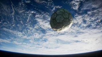 old soccer ball in space on Earth orbit video