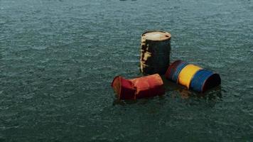 Industrial barrels thrown into the lake for garbage and make a pollution video
