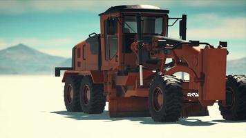 road grading machine on the salt desert road video