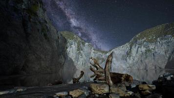 hyperlapse of night starry sky with mountain and ocean beach in Lofoten Norway video