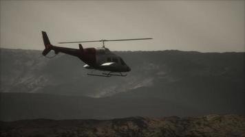 extreme slow motion flying helicopter near mountains with fog video