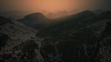 dramatic sky over rocky mountains at sunset video